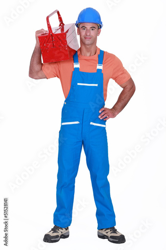 Photo: Craftsman with tool box over his shoulder Craftsman with tool box over his shoulder
