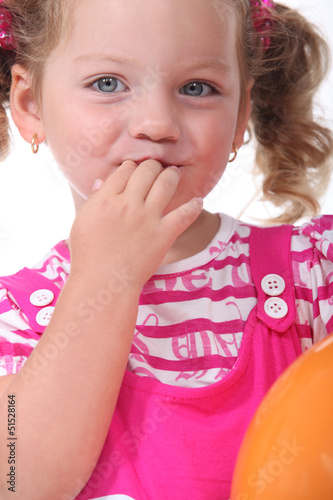 Photo: Girl with fingers in mouth Girl with fingers in mouth