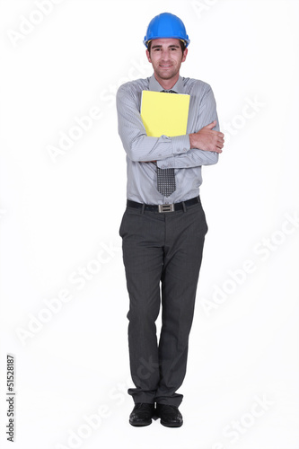 Photo: Man with helmet holding report Man with helmet holding report