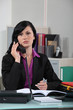 Receptionist writing note for boss