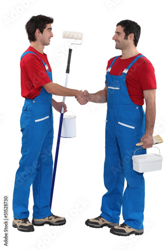 Photo: Decorating duo shaking hands Decorating duo shaking hands