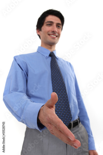 Photo: businessman giving his hand for a handshake businessman giving his hand for a handshake