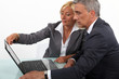 Mature business couple with a laptop