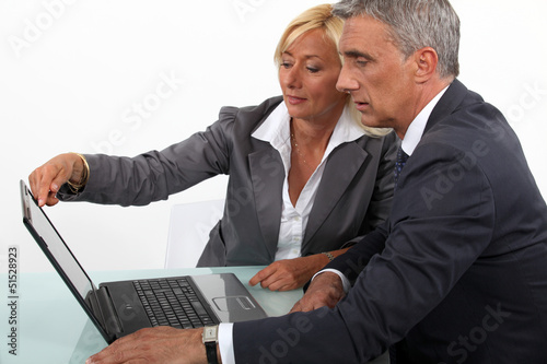 Photo: Mature business couple with a laptop Mature business couple with a laptop