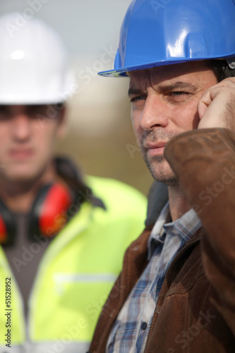 Photo: Construction worker on the phone Construction worker on the phone