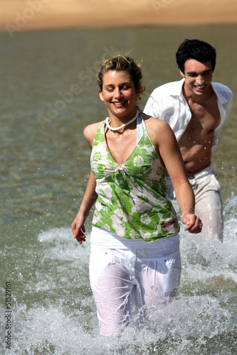 Photo: Couple running in the water Couple running in the water