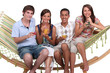 Photo: Friends drinking cocktails on a hammock Friends drinking cocktails on a hammock