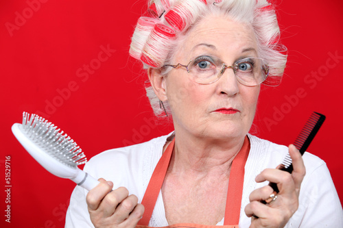 Photo: Senior woman with hair curlers Senior woman with hair curlers