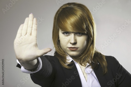 Photo: Young woman making stop gesture sign Young woman making stop gesture sign