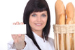 Female baker showing businesscard