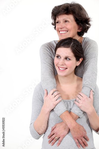 Photo: mother and daughter embracing mother and daughter embracing