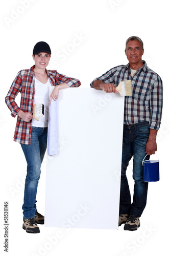 Photo: two painters holding a white ad board two painters holding a white ad board