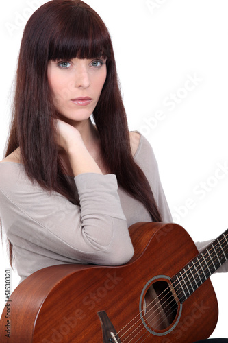 Photo: Gorgeous woman holding guitar Gorgeous woman holding guitar