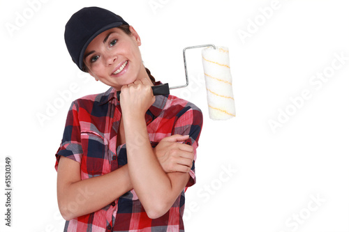 Photo: Shy woman holding paint roller Shy woman holding paint roller