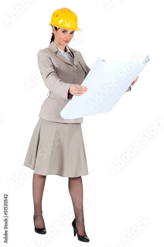 Photo: A female architect checking her plans. A female architect checking her plans.