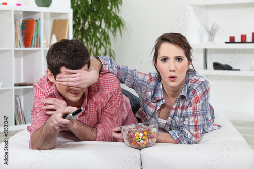 Photo: Young couple watching television Young couple watching television