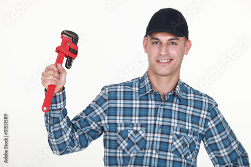 Photo: Man with an adjustable wrench Man with an adjustable wrench