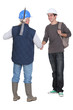 Manual workers shaking hands