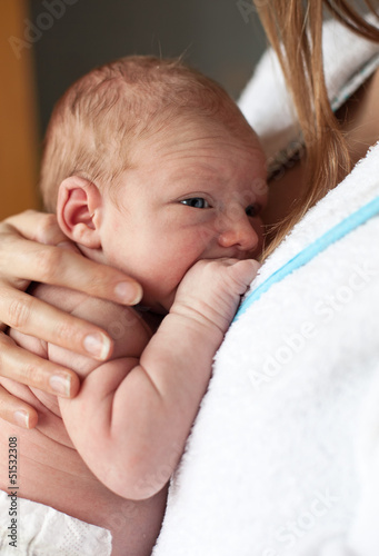 Photo: Closeup of newborn baby boy in mother's arms Closeup of newborn baby boy in mother's arms