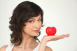 Photo: young woman holding a plastic hearth in her hand young woman holding a plastic hearth in her hand