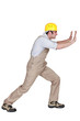 Foreman pushing hard against a wall