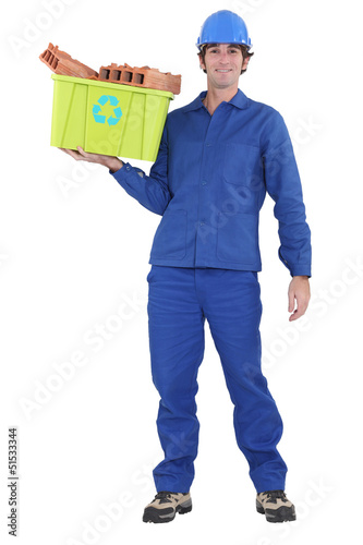 Photo: A manual worker recycling. A manual worker recycling.