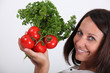 Photo: Woman holding bunch of tomatoes Woman holding bunch of tomatoes