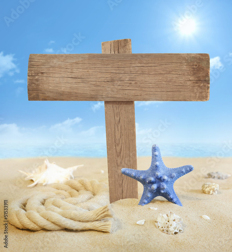 Photo: Signboard on the beach with sun and sky near sea Signboard on the beach with sun and sky near sea