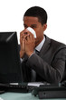 Foto: Businessman blowing his nose Businessman blowing his nose