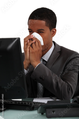 Photo: Businessman blowing his nose Businessman blowing his nose