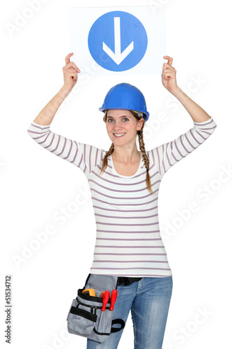 Photo: Woman holding a traffic sign Woman holding a traffic sign