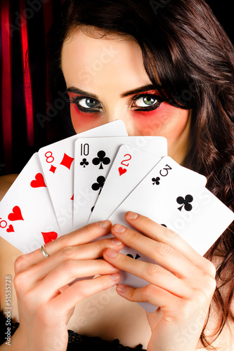 Photo: Mysterious female holding deck of playing cards Mysterious female holding deck of playing cards