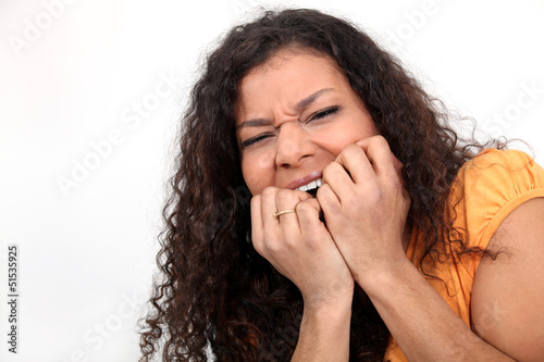 Photo: Nervous woman biting nails Nervous woman biting nails