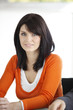 Casual brunette sat at desk
