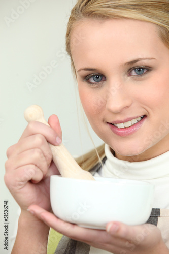 Photo: Blonde woman with mortar Blonde woman with mortar