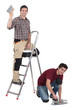 Two decorators working on site