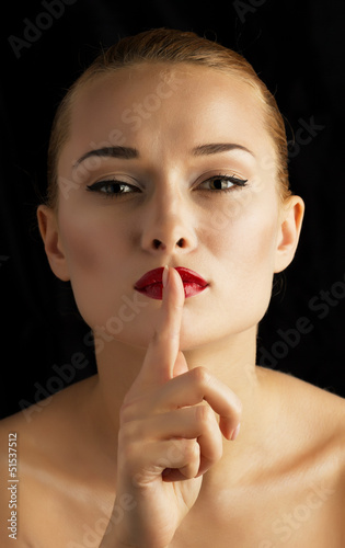 Photo: beautiful girl with his finger near the lips beautiful girl with his finger near the lips