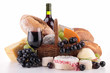 wicker basket with bread, cheese and wine