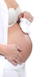 Photo: Pregnant woman holding baby shoes Pregnant woman holding baby shoes