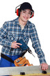 Foto: Man operating a power tool Man operating a power tool