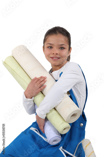 Photo: Little girl holding wallpaper rolls Little girl holding wallpaper rolls