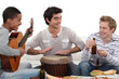 Foto: Three house-mates eating burgers and playing music Three house-mates eating burgers and playing music