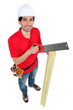 A carpenter sawing wood.