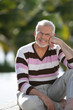 Elderly man sat in garden