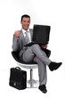 Successful man sat in chair with laptop