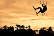 Kiteboarding at sunset. High jump