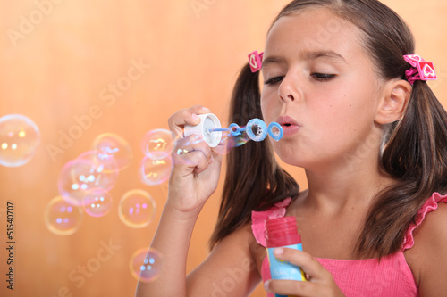Photo: Girl blowing bubbles of soap Girl blowing bubbles of soap