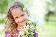 Little girl with branches blossoming apple tree