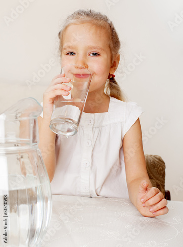 Photo: Child with glass pitcher water Child with glass pitcher water