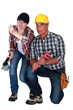 Male and female workers crouching